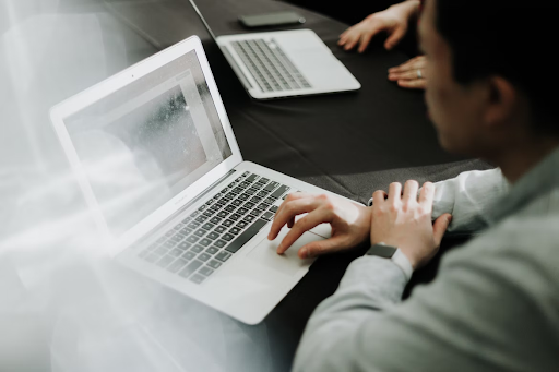 Person sitting with a laptop in front of them