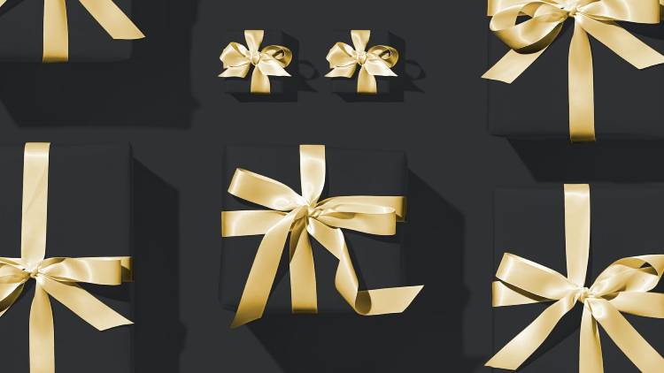 Black gift boxes with gold bow ties